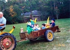 HarryViosca_025cs -- Driving tractor Harry Viosca Jr.On back: A few grand children in the first Easter hayride.1998