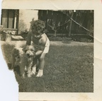 VicVioscaAlbum_074 -- On back: Victor Willard Vioscaa Jr. with his dog "Rags" in yard - 5762 Catina St. 3 years old.